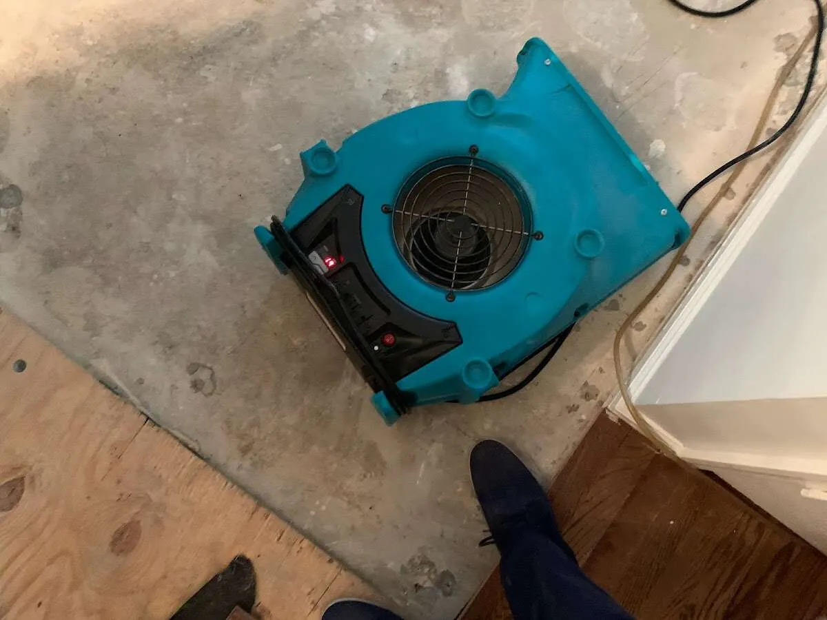 Air mover drying subfloor during Leak Detection & Repair in St. Johns